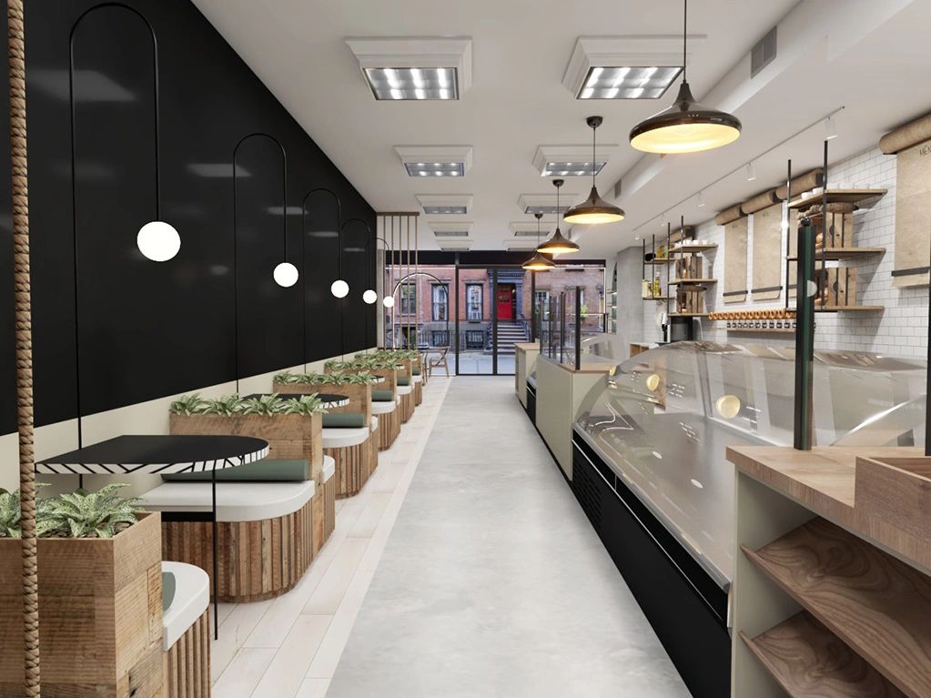 Modern cafe interior with wooden seating, black walls, and pendant lighting.