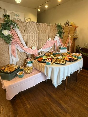 A beautifully decorated buffet table with a variety of appetizers and snacks.