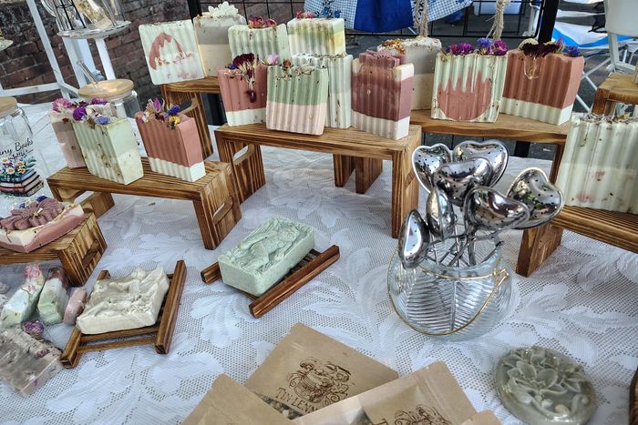 Stack of books next to pencils in a holder and a camera.