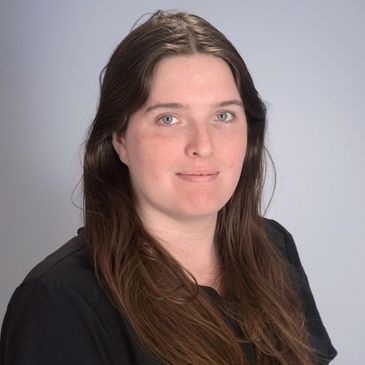 Headshot of a brunette woman in a black shirt