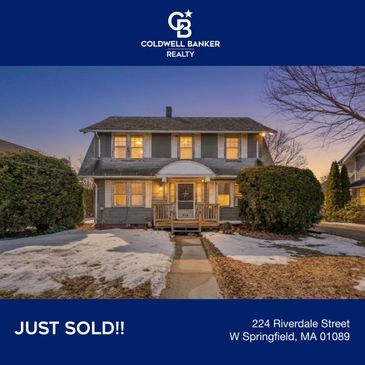 Two-story house at dusk just sold by Coldwell Banker Realty.
