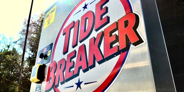 Close-up of a Tide Breaker vending machine with bold red lettering.
