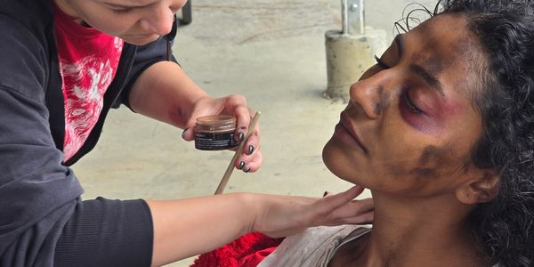 Makeup artist applies effects to a model's face.