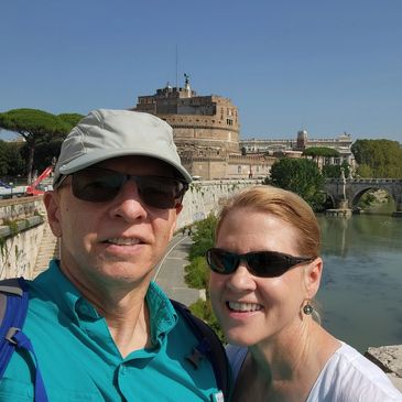 In Rome, Italy, along the Tiber River with the Castel Sant'Angelo in the background.
