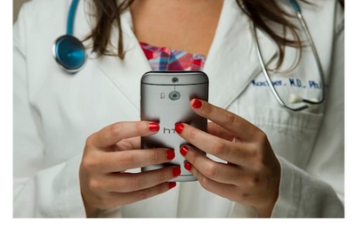 MD in Lab Jacket on cell phone