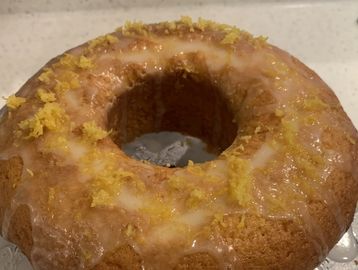 Glazed bundt cake with lemon zest topping.