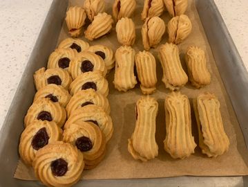 Tray of homemade cookies, some with jam centers and others plain.
