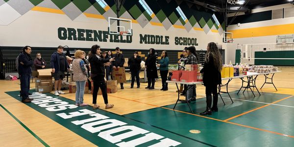 Group meeting in Greenfield Middle School gymnasium.