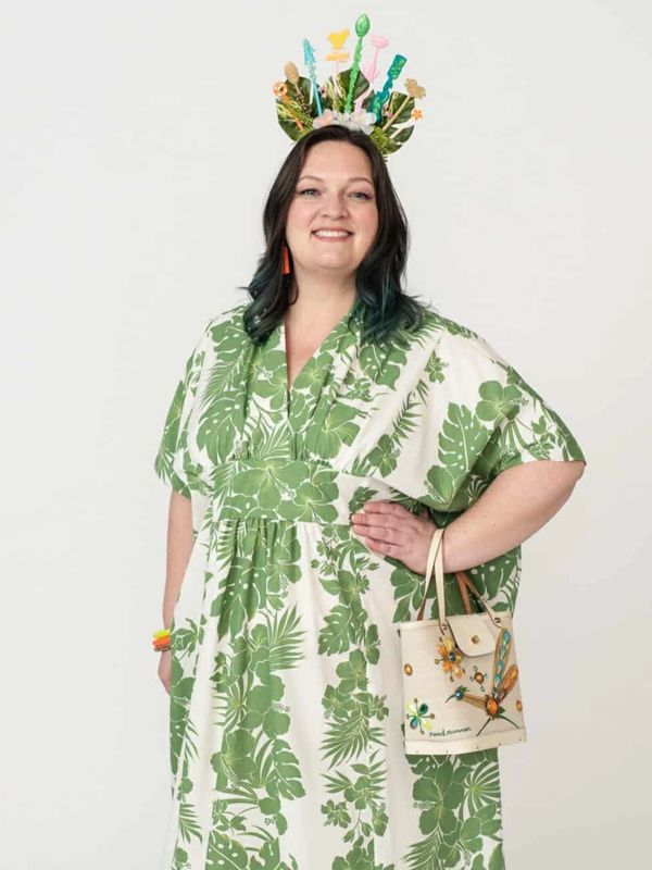 Woman in a green and white floral dress with matching accessories.