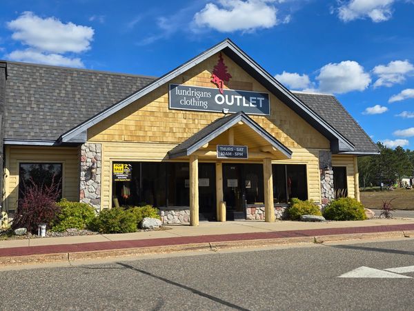 Exterior of Lundrigans Clothing Outlet under a clear blue sky.