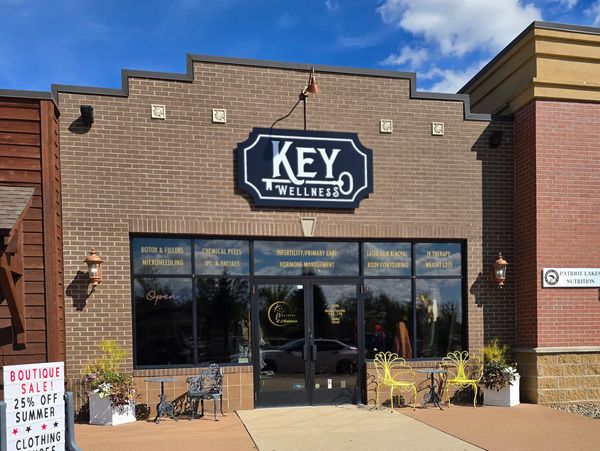 Exterior of Key Wellness center with promotional signage and seating.