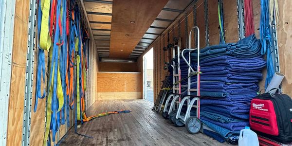 Empty moving truck with moving straps and blankets