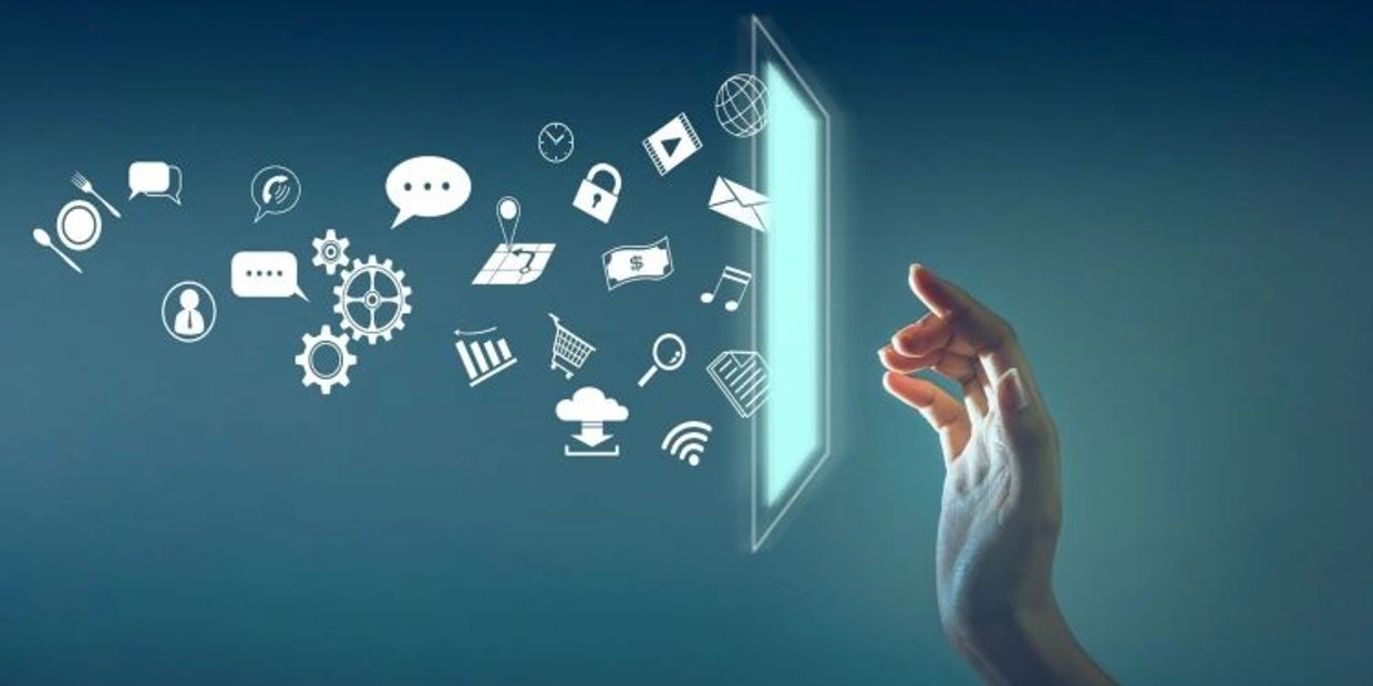 Hand & computer screen with items flowing behind it: cloud, shopping cart, lock, email, widgets, etc