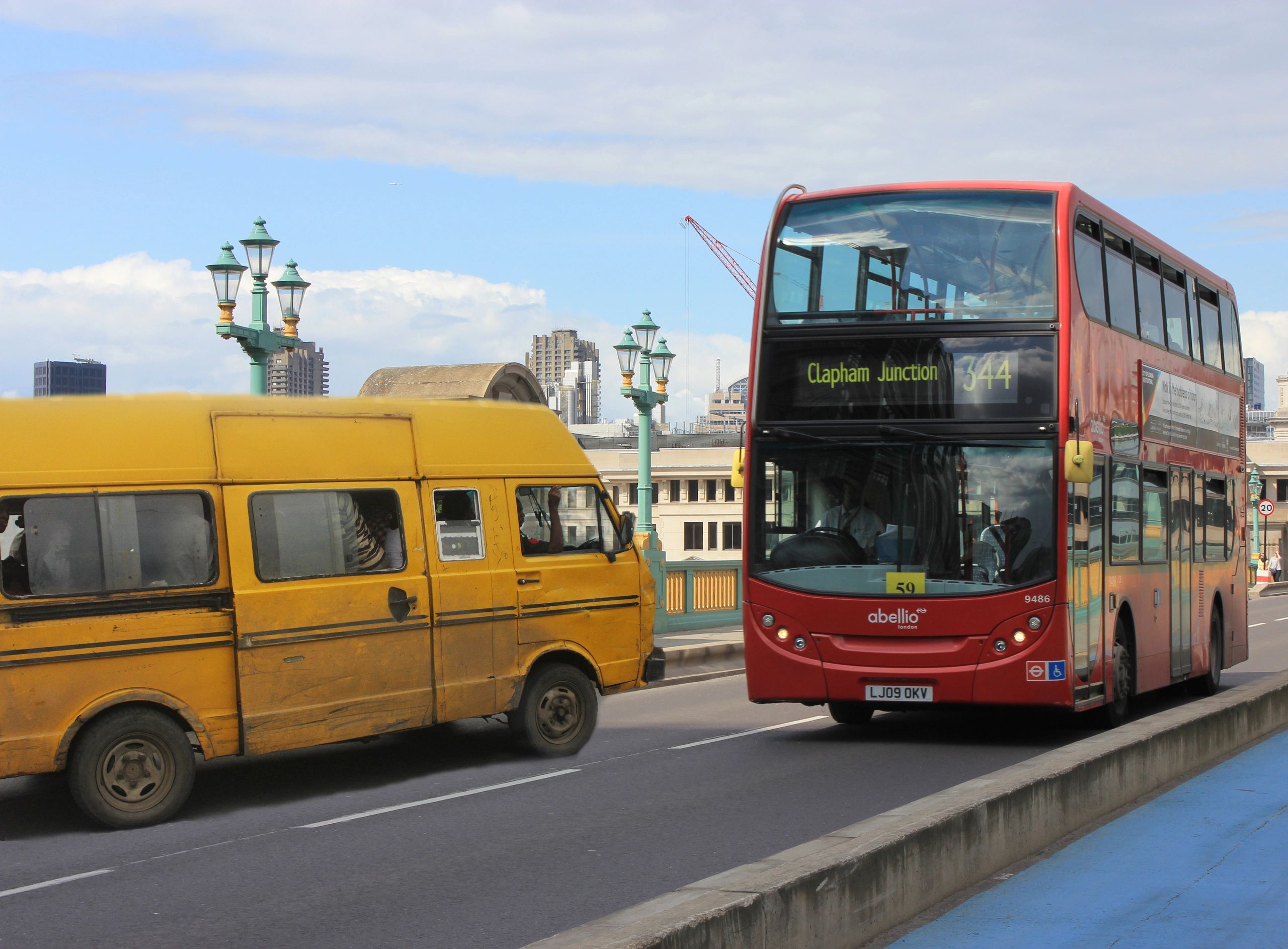 A yellow Danfo from Lagos finds itself crossing paths with a red London Bus on Tower Bridge.