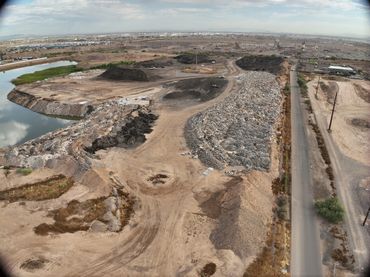 Aerial drone view of large concrete rubble piles at a Phoenix site used for volumetric measurement.