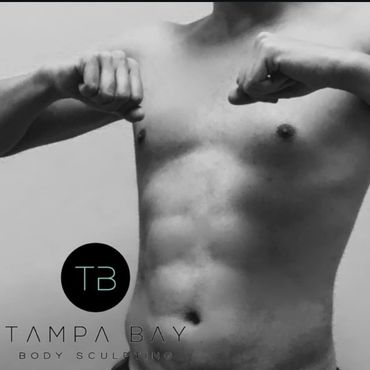 Black and white photo of a shirtless man flexing his arms.