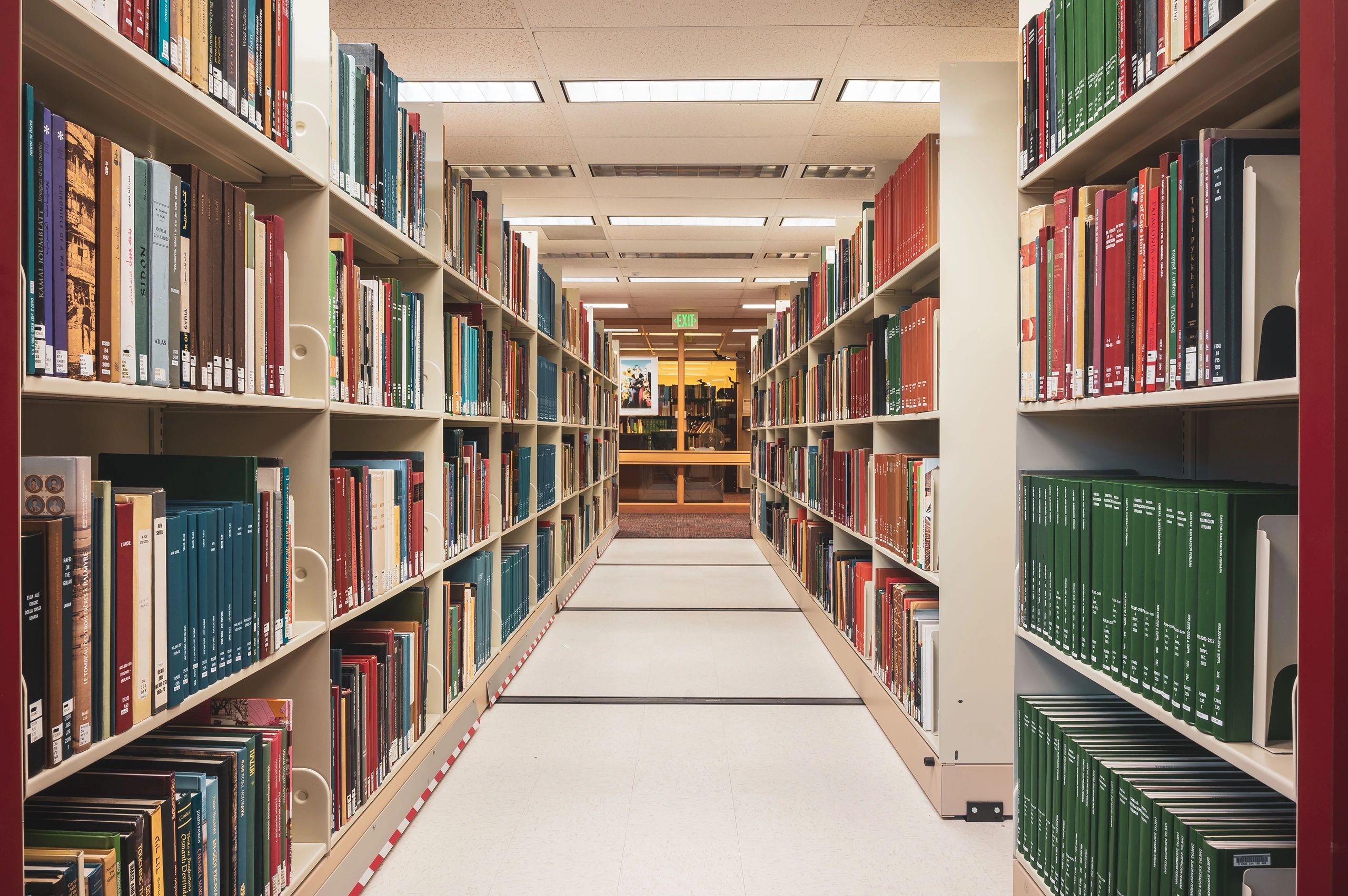 Library aisle with shelves full of books.