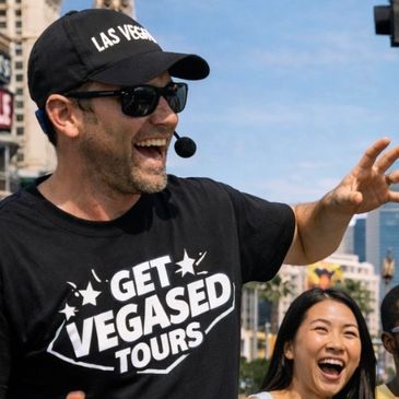 Tour guide enthusiastically leading a Las Vegas tour with a microphone headset.