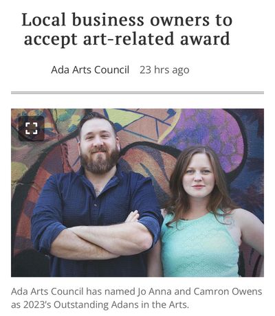 Camron & JoAnna Owens smiling in front of the Ada Public Library mural