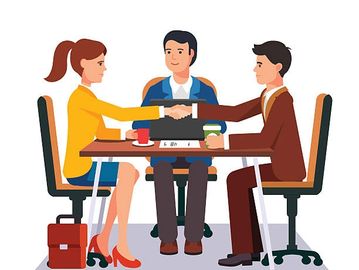 Business meeting handshake across a table.