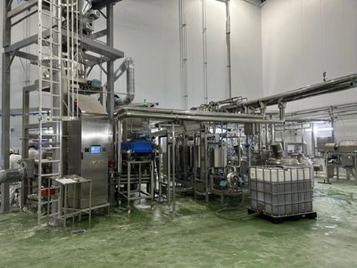 Industrial processing equipment in a clean factory setting.