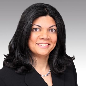 Professional woman with dark hair and a black blazer.
