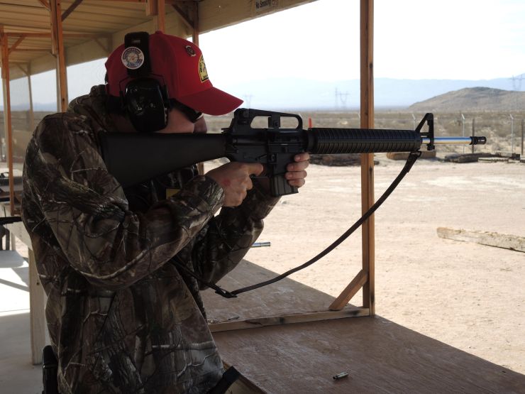 Person aiming a rifle at the West Victor Valley Shooting Club outdoor range