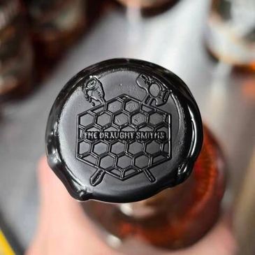 Wax-sealed bottle top with 'The Druggist Smiths' logo embossed.