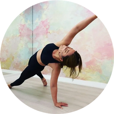 Woman practicing yoga in a spacious, colorful room.