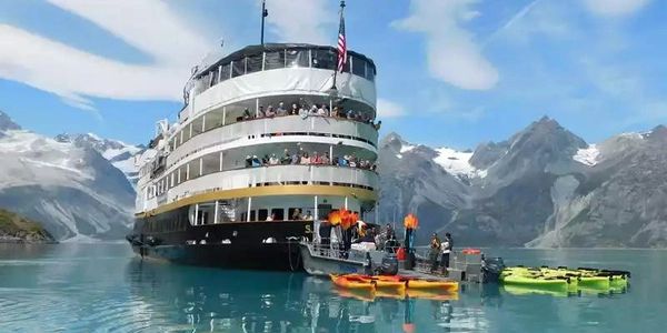 Tourist ship on a mountain lake with kayaks.