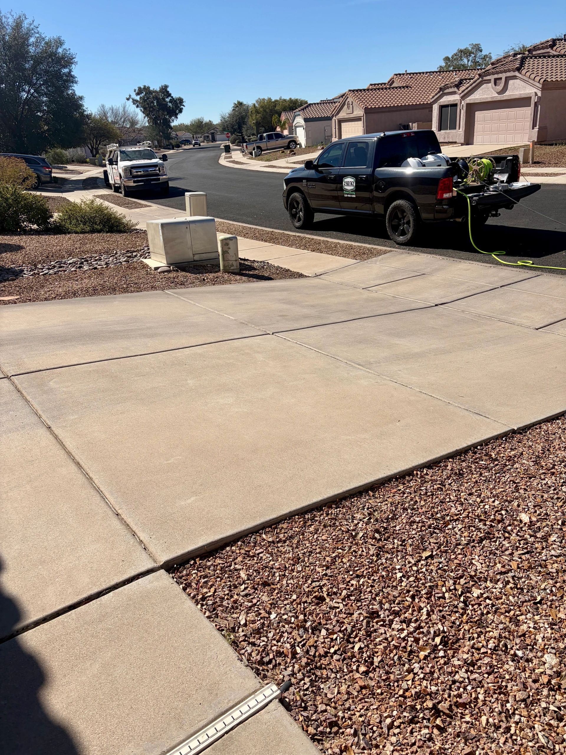 Residential driveway covered in dirt and stains before professional pressure washing.