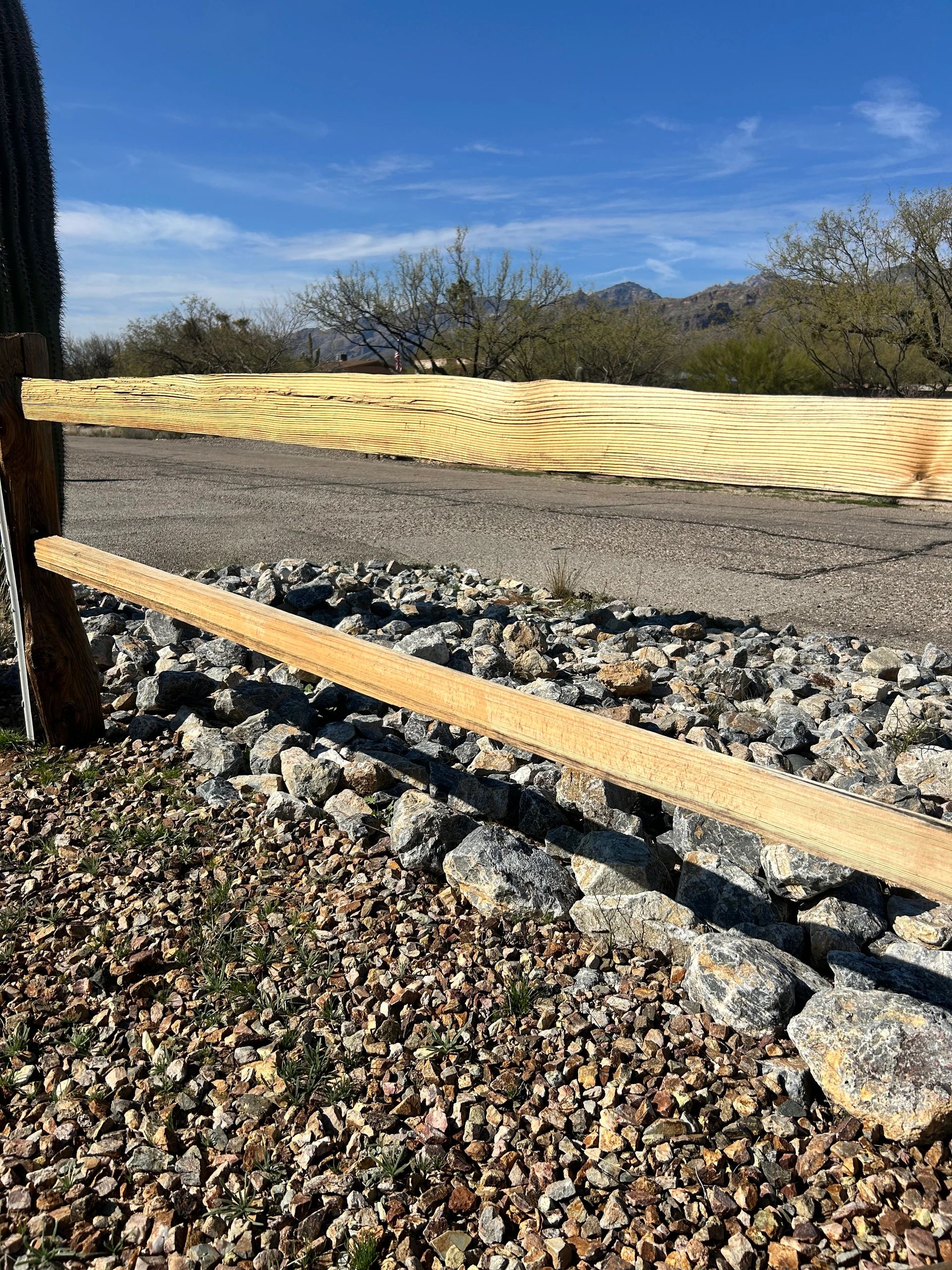 Residential wood fence restored and clean after professional pressure washing by Skyros.