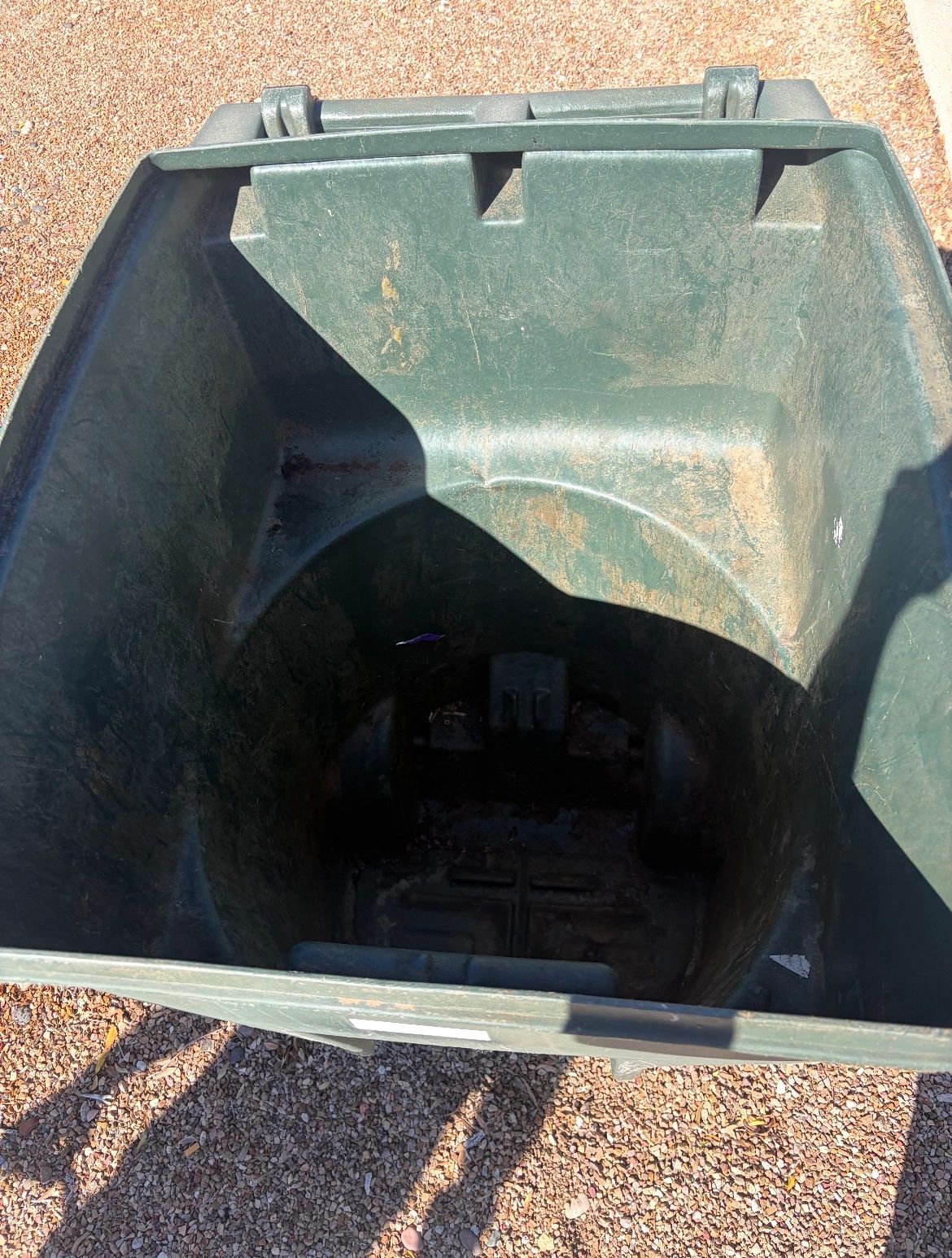 Residential trash bin covered in grime and dirt before professional pressure washing.