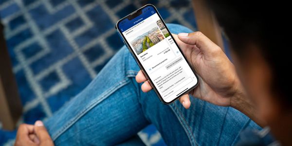 Image of someones phone as they are searching for travel booking details.