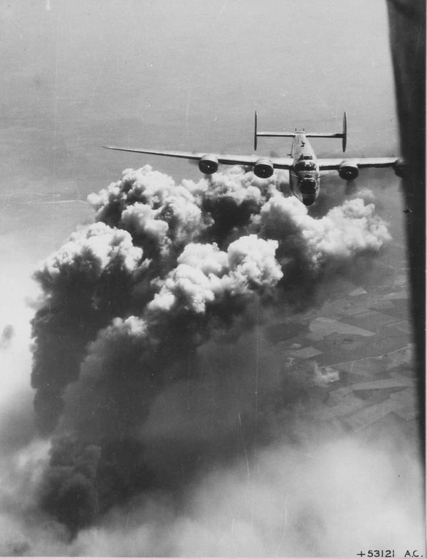  Bomber flying over smoke clouds.