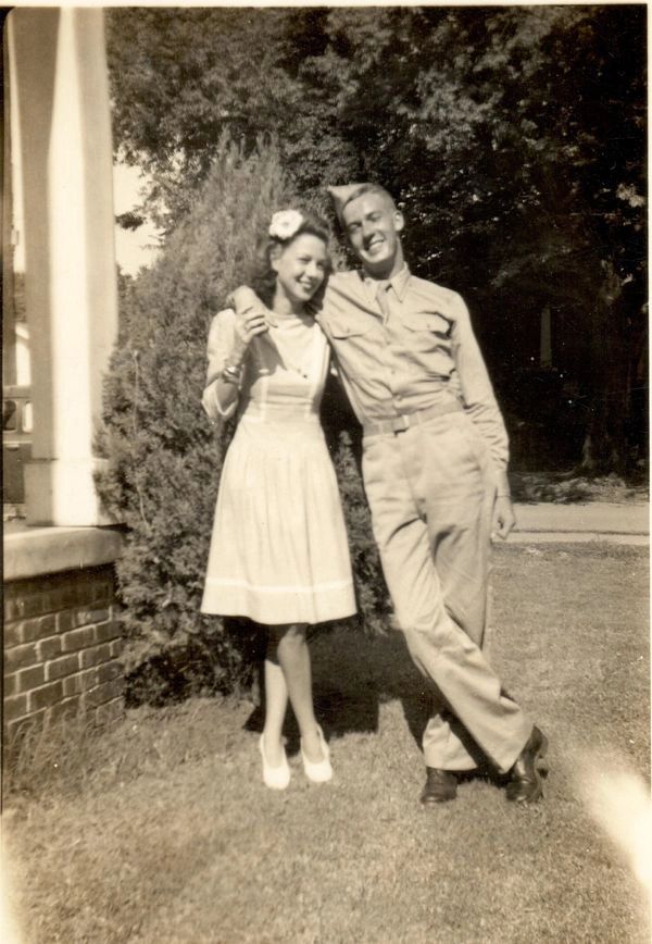 Soldier and woman posing together.
