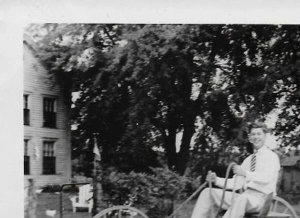 Person driving a vintage buggy.
