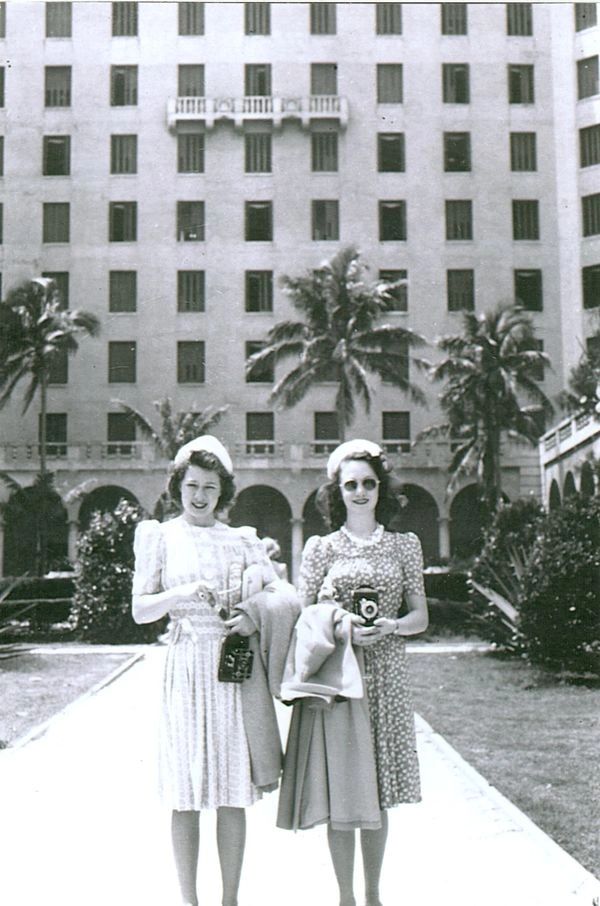 Two women in white dresses.