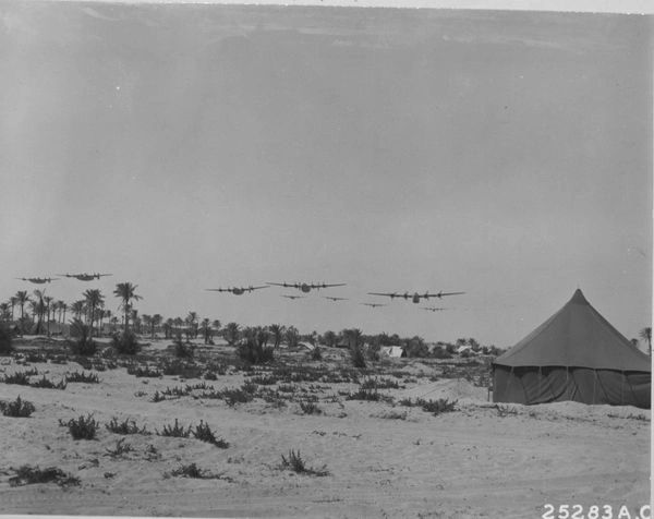  Multiple planes flying over beach.
