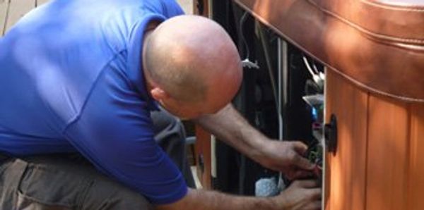 Man repairing or inspecting electrical components.