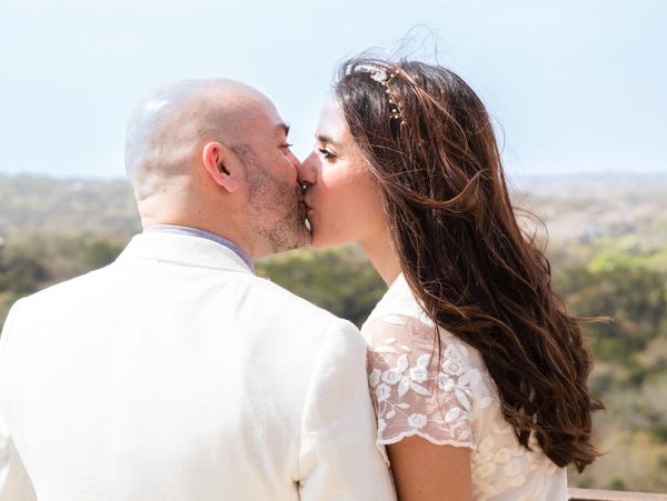 Wedding photography near me in Austin Texas takes photos of the bride and goom in white at an outdoo