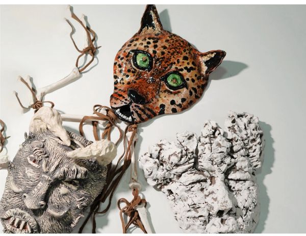 3 handmade ceramic masks. One human, one leopard, and one krampus-looking creature.