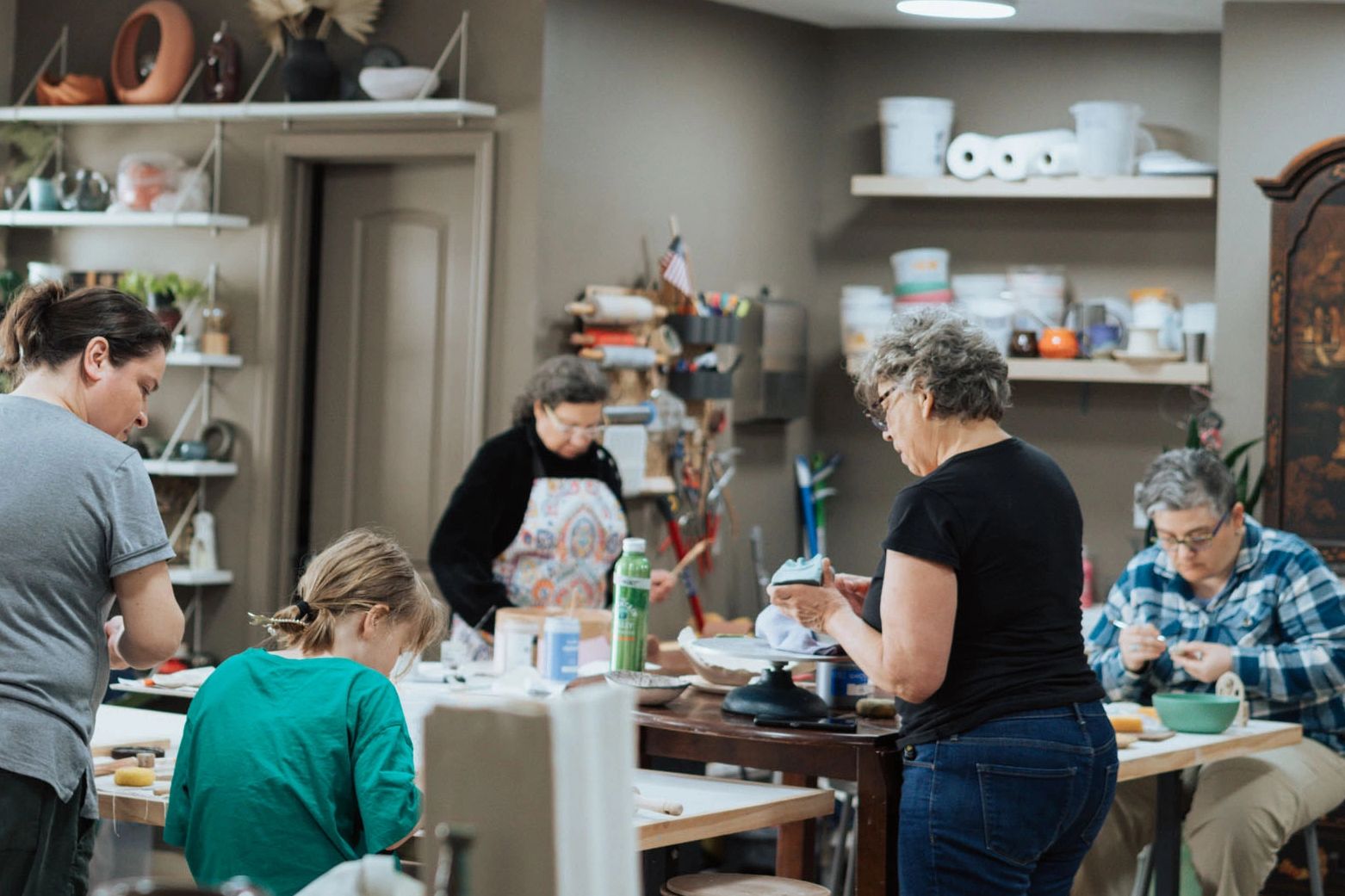 Group of people, potters in a pottery studio working on their art