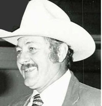Black and white photo of Ralph Clark, past fair manager, in suit and cowboy hat