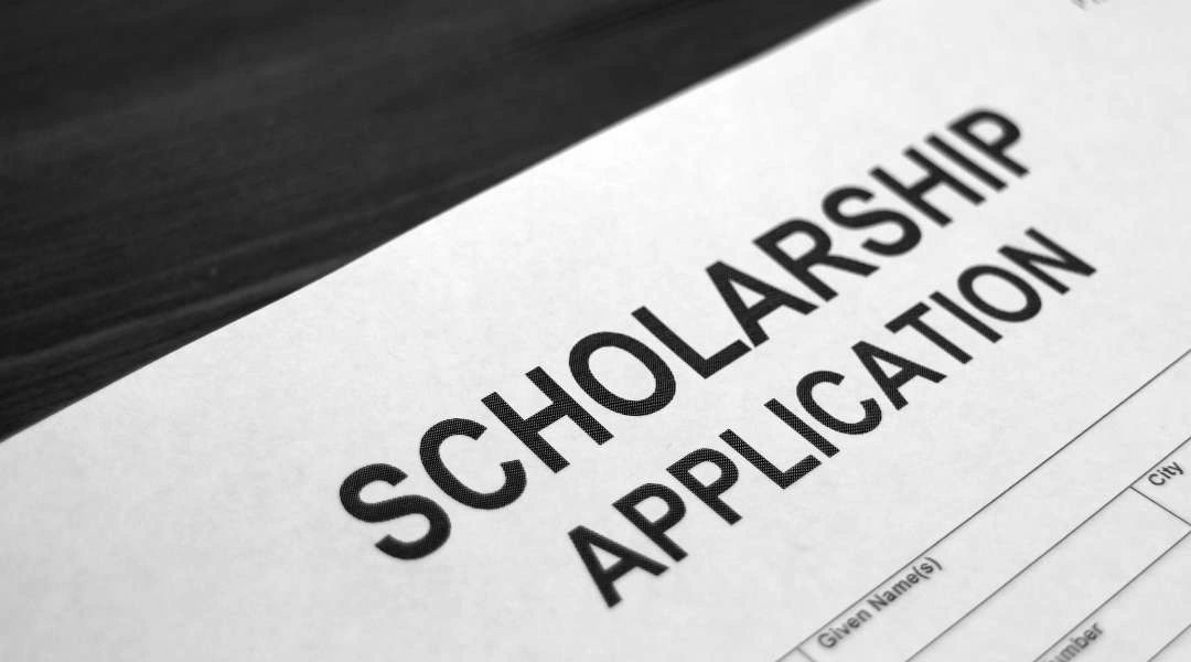 paper with the words scholarship application at the top