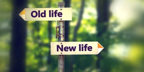 Signs showing old life to the left and new life to the right
