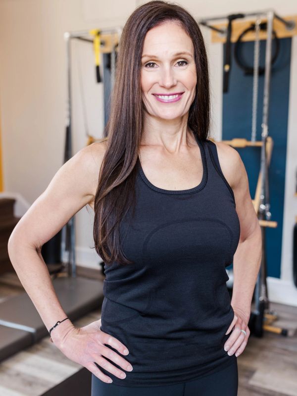 Smiling woman in workout clothes at the gym