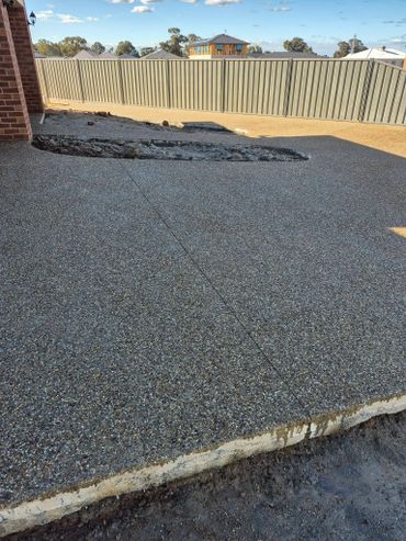 Newly poured concrete patio with an unfinished trench area.