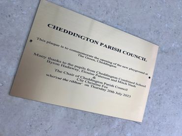 laser engraved writing on a brush gold plastic/laminate plaque. bench memorial, signs