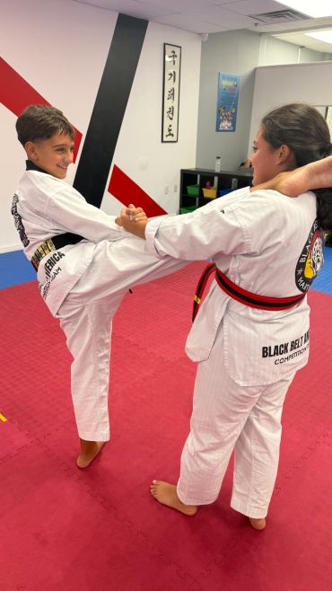 Two martial artists practicing a self-defense move.